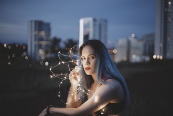 Woman Holding String Lights