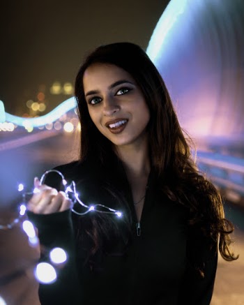 Woman Holding String Lights
