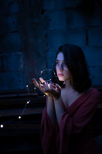Woman Holding String Lights