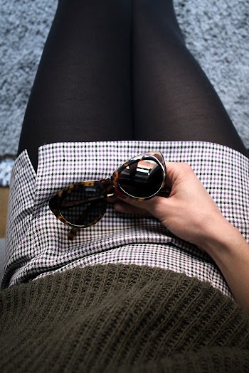 Woman Holding Sunglasses