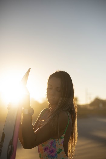 Woman Holding Surfboard and Posing Outdoor