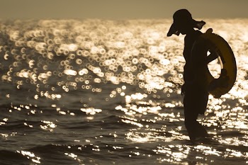 Woman Holding Swimming Ring Standing on Sea