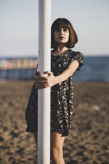 Woman Holding To A Post While Posing