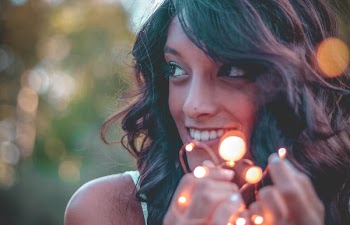 Woman Holding Turned-on String Lights