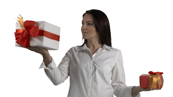 Woman holding two gift boxes in hands on white background. One ...