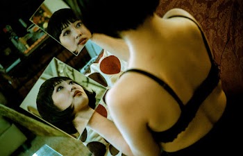 Woman Holding Two Mirrors