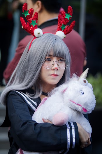 Woman Holding Unicorn Plush Toy