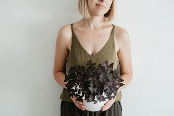 Woman Holding Vase With Flowers