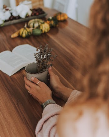 Woman Holding Vase with Flowers 