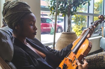 Woman Holding Violin by the Window