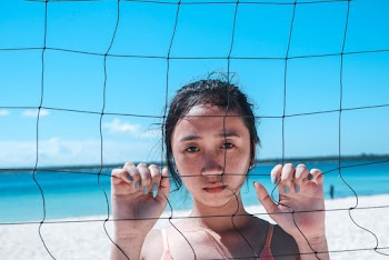 Woman Holding Volleyball Net