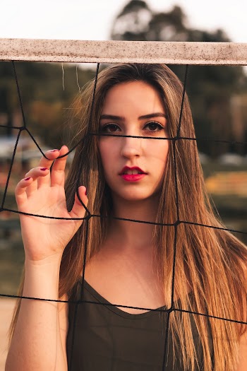 Woman Holding Volleyball Net