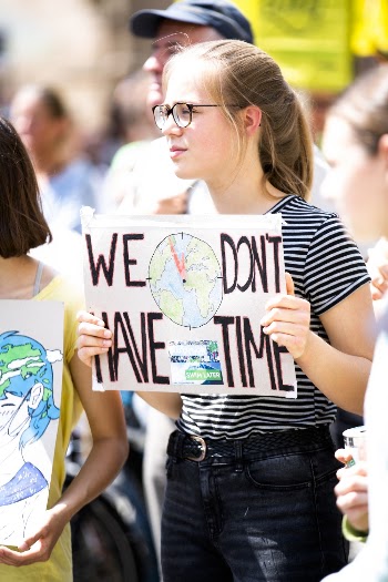 Woman Holding We Don't Have Time Signage