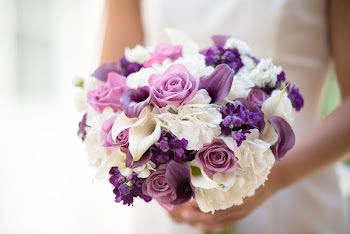 Woman Holding White And Purple Flowers