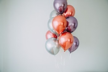 Woman Holding White and Red Balloons