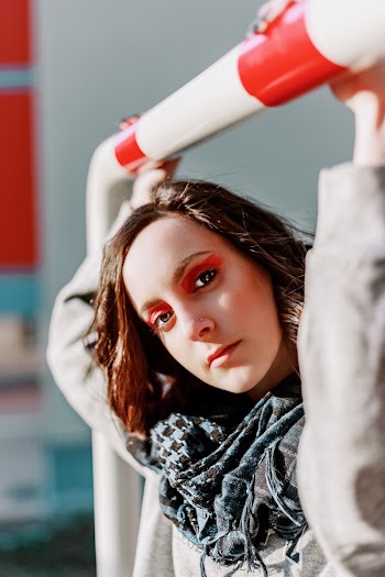 Woman Holding White and Red Bar