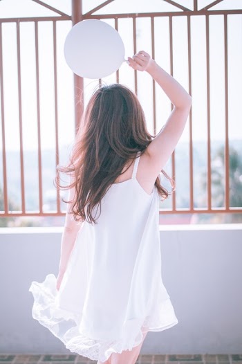 Woman Holding White Balloon