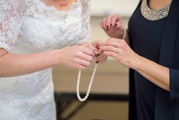 Woman Holding White Bead Necklace