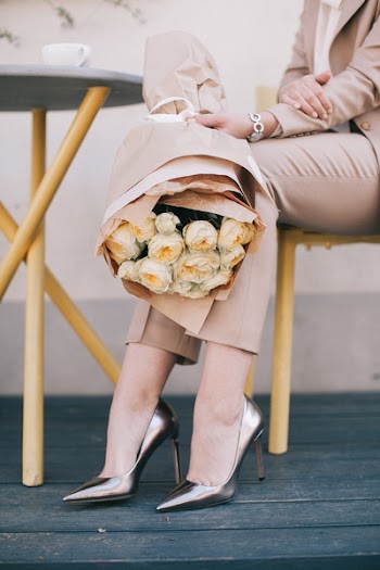 Woman Holding White Bouquet of Roses