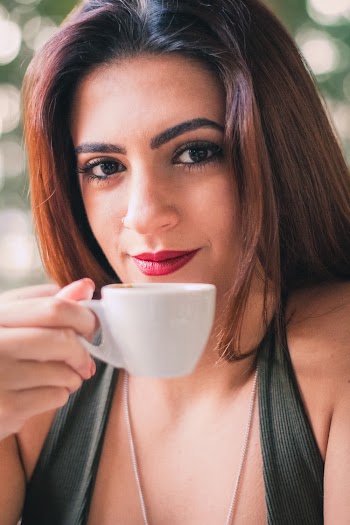 Woman Holding White Ceramic Cup