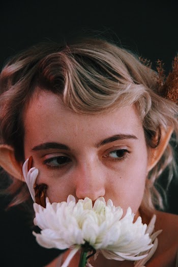 Woman Holding White Chrysanthemum