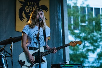 Woman Holding White Electric Guitar
