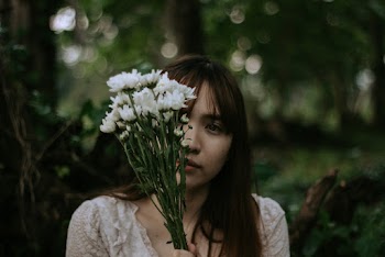 Woman Holding White Flowers