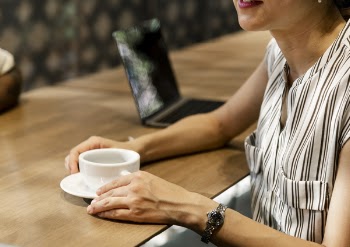 Woman Holding White Mug on Saucer
