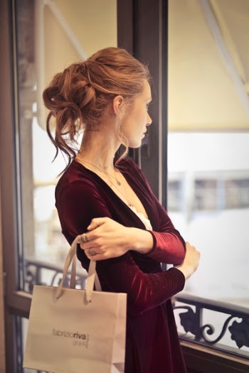 Woman Holding White Paper Bag While Looking at the Window