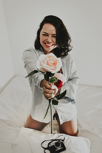 Woman Holding White Rose in White Dress Shirt