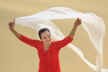 Woman Holding White Scarf At The Desert