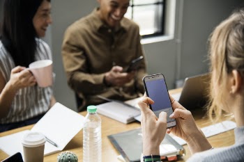 Woman Holding White Smartphone With Black Case