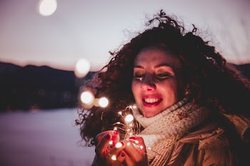 Woman Holding White String Lights