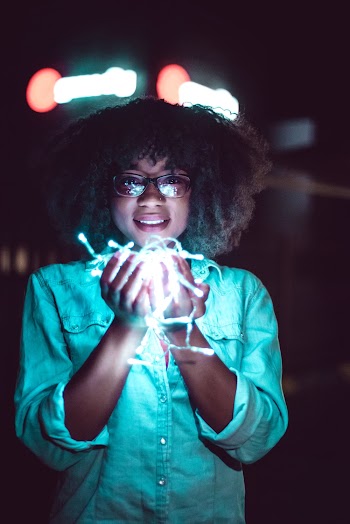 Woman Holding White String Lights