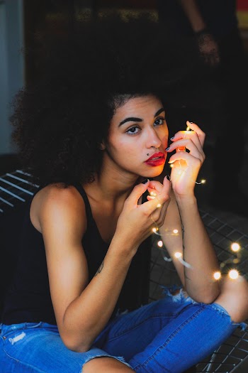 Woman Holding White String Lights