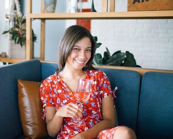 Woman Holding Wine Glass Sitting in Sofa