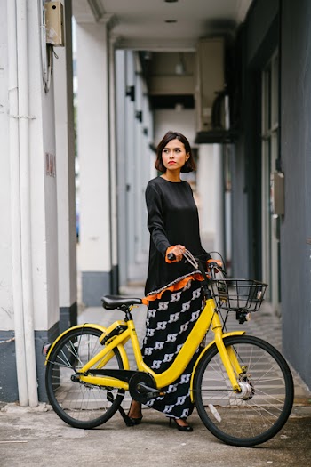 Woman Holding Yellow Bike at Daytime
