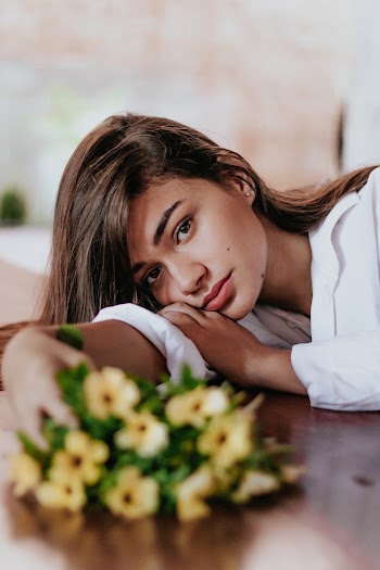 Woman Holding Yellow Flowers
