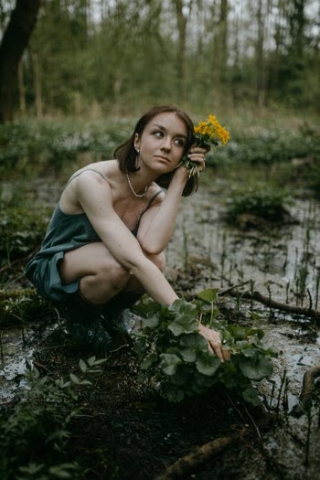 Woman Holding Yellow Flowers · Free Stock Photo