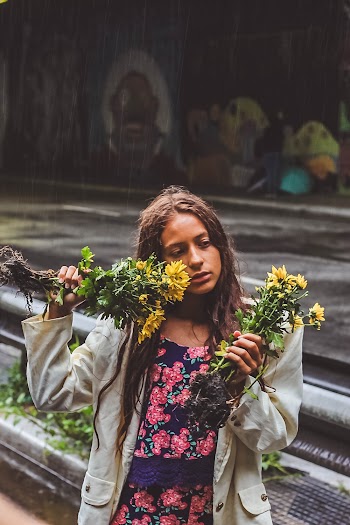 Woman Holding Yellow Mums Flowers