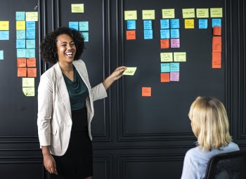 Woman Holding Yellow Sticky Note