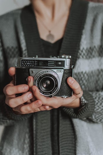 Woman Holdinng Black Analogue Camera