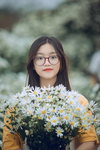 Woman Holds Bouquet of Flowers