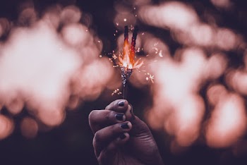 Woman Holds Lighted Sparkler