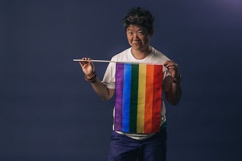 Woman Holds Pride Flag And Smirks