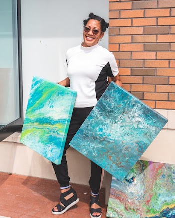 Woman Holds Two Abstract Canvas Paintings