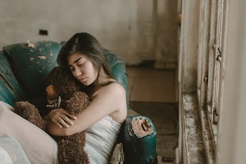 Woman Hugging A Teddy Bear