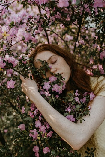 Woman Hugging Flowering Tree