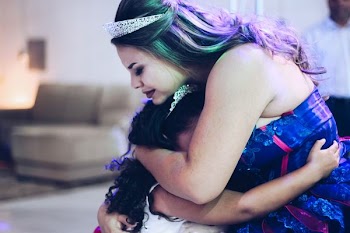 woman hugging girl inside room