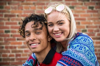 Woman Hugging Man in Red Shirt